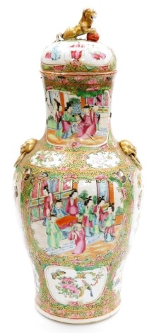 A 19thC Chinese Canton porcelain vase and cover, of baluster form, with gilt dog of fo finial and dog of fo mask handles, decorated with panels of figures, birds, butterflies and flowers, against a foliate ground, 49.5cm high. (AF)