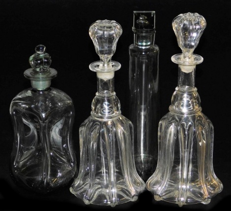 A pair of Victorian glass mallet shaped decanters and stoppers, an hour glass decanter and stopper, and a late 20thC spirit decanter and stopper. (4)