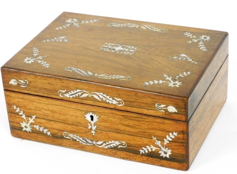 A Victorian rosewood and mother of pearl work box, decorated with flowers and scrolling leaves, the hinged lid opening to reveal a fitted interior with a removable tray containing scissors, reels, etc., 12cm high, 28cm wide, 20.5cm deep.