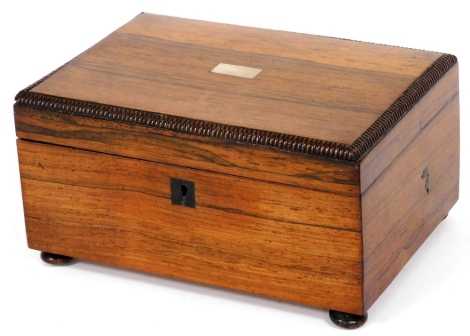 A 19thC rosewood workbox, the hinged lid with a vacant rectangular cartouche and a mulled border enclosing a fitted interior, on bun feet, 22cm wide.