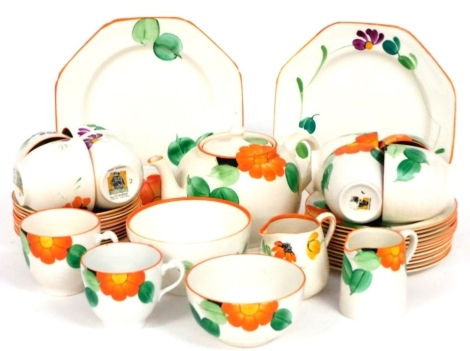 A Grays Pottery Art Deco tea service, painted with flowers and leaves, printed mark, comprising tea pot, cream and milk jugs, two graduated sugar bowls, pair of bread plates, ten tea cups, saucers and twelve tea plates.