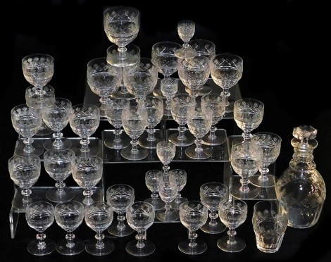 An Edwardian suite of cut table glass, to include tumblers, sherry glasses, small wine glasses, etc., and a matching decanter. (a quantity)