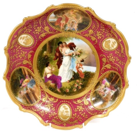 A late 19thC Vienna style porcelain dish, decorated with reserves of classical and mythological figures, signed Liebal, against a puce ground, gilt heightened with flowers, leaves and figural reserves, signed Liebal, indistinct beehive mark to underside, 