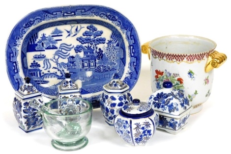 A blue printed Willow pattern meat dish, a glass pestle and mortar, various Oriental jars and covers, and a Moyses Stevens two handled wine cooler or jardiniere, printed with flowers. (a quantity)