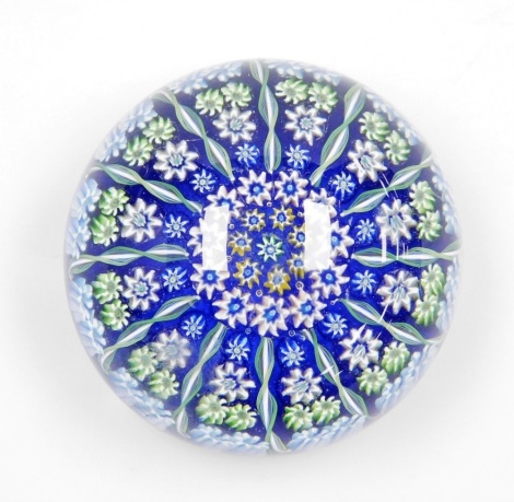 A Paul Ysart glass millefiori paperweight, of concentric form, interspersed with spiral twist canes and a central 'Y' cane, 7.5cm diameter.