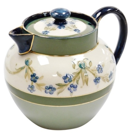 A Macintyre and Co pottery teapot and cover, with sparrow beak spout, the body decorated with swags and forget me not, with two tone green banding and gilt highlights, made for W. Coupe, St Anne's-on-the-Sea, printed marks, 13cm high.