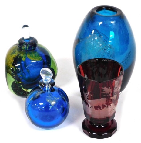 Four items of glass, comprising a Bohemian ruby flashed goblet engraved with a stag, 11cm high, two Mdina scent bottles and stoppers, and a Mdina bullet shaped vase.