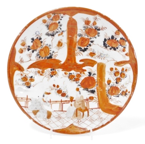 A Japanese Meiji period kutani dish, decorated with panels of flowers, blossom, and interior scene, red mark to underside, 21.5cm diameter.