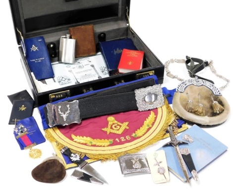 A group of Masonic regalia relating to St Andrew Lodge number 126, to include a gilt metal medal, Silver Jubilee 1955-1980 Lodge Buchanan medal, Sporran, Dirk, Masonic Speech Making Book, hip flask in leather case, coin purse, belt buckle, apron, etc., co