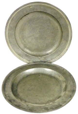 A late 18th/early 19thC pewter charger, with reeded rim, impressed marks and initials WN, 46cm diameter, and another similar of plain design, 46cm diameter. (2)