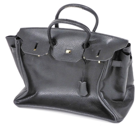 A black leather handbag, with gold coloured hardwear and turn lock closure, 37cm wide.