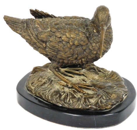 A bronze figure of a Sandpiper, cast on a naturalistic ground, and oval black marble base, unsigned, 18cm high.