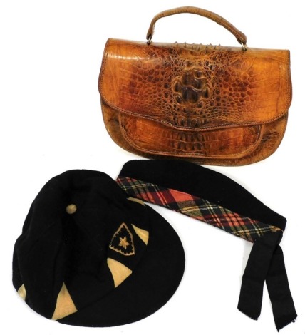 A Scottish regimental Glengarry cap with tartan band, a segmented school or sporting cap, and a crocodile skin bag. (3)