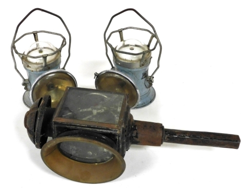 A black painted tin and brass carriage lamp, 46cm high, and two Siemens Full O'Power lamps. (3)