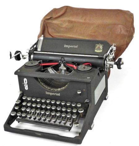 An Imperial typewriter, in black metal case, retailed by JH Todd and Sons, Lincoln.