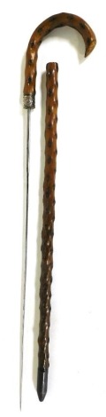 A late 19th/early 20thC yew sword stick, with silver coloured metal collar, 87cm high.