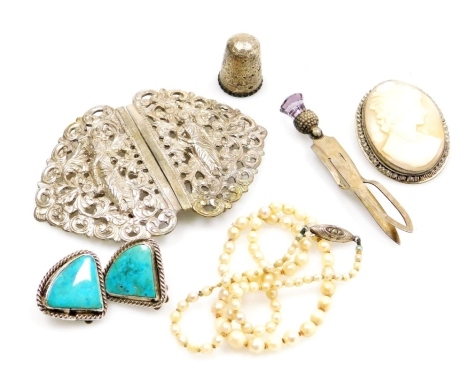 A group of costume and dress jewellery, comprising a cameo brooch, an Eastern white metal belt buckle, silver thimble, marks indistinct, pearl necklace, a pair of silver coloured metal clip on earrings, and a silver bookmark mounted with a faceted purple 