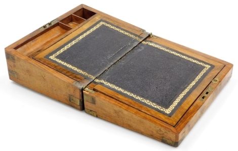 A Victorian walnut and brass bound writing slope, the hinged lid enclosing a leather and gilt tooled inset, with pen and ink well recesses, brass shield escutcheons, 30cm wide.