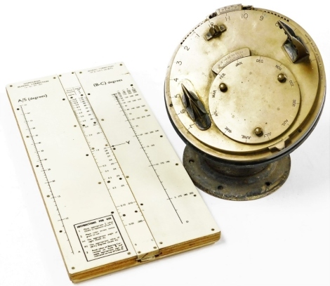 A Pilkington and Gibbs Helio chronometer, with a brass dial, on an iron base, 28cm high, and a bearing correction board. (2)