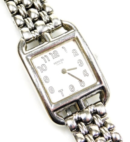 A Hermes of Paris lady's stainless steel cased wristwatch, with square watch head and numeric outer dial, on a five row outer bracelet numbered CC1-210, 1740985, the dial 2cm wide.