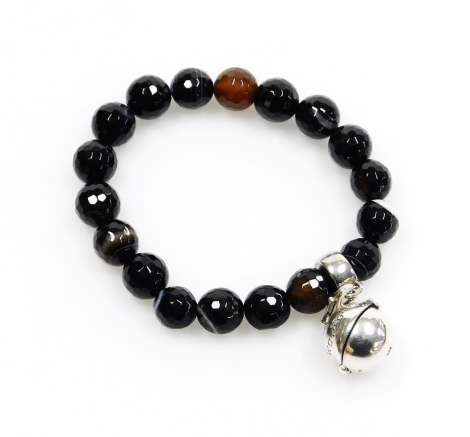 A World Trade Centre carved black agate bracelet, the bracelet with circular faceted beads, and a white metal loop with pendant drop marked World Trade Centre with opening to reveal a love heart, approx 10cm long overall but on expanding bracelet, 34g all