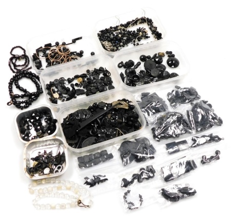 A group of loose jet and other pieces, bracelet parts, pendants, etc., together with a group of crystal and imitation jet necklaces. (a quantity)