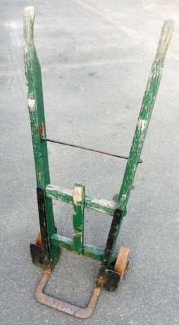 A set of wooden and iron sack trucks, with solid wheels, 122cm high.