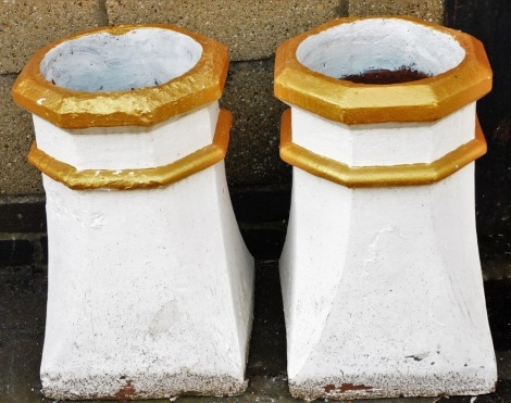 A pair of late Victorian square section chimney pots, each with an octagonal top and canted sides, later painted white and gilt, 50cm high.