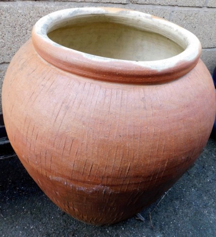 A stoneware olive type jar, with geometric design, 73cm high.