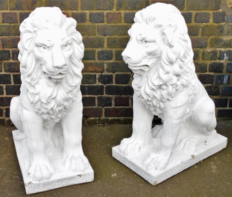 A pair of composition garden lions, each seated on their haunches, on square bases, later painted white, 95cm high.