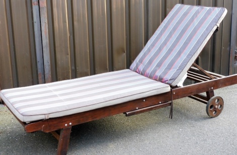 A hardwood garden lounger, with adjustable back rest, etc., on wheels with rubber rims, covers (AF), 20cm long.