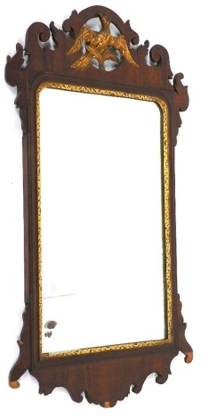 A Georgian mahogany fret cut wall mirror, the top decorated with a ho-ho bird, with gilt highlights, 80cm x 47cm.