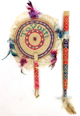 A Hawaiian tribal sword and fan, made from coloured plaited palm, embellished with sharks teeth, and feathers of the frigat bird, c.1950s.