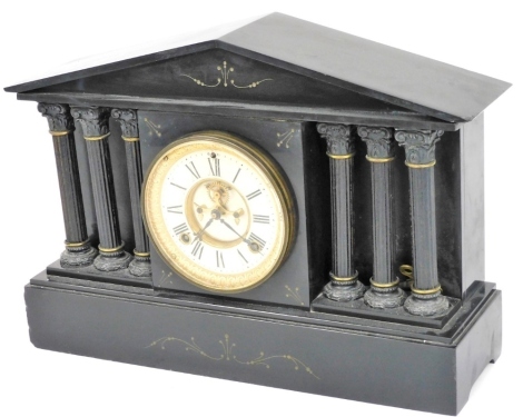 A Victorian black slate mantel clock, circular dial with visible brocot escapement, chapter ring bearing Roman numerals, Ansonia Clock Company eight day movement with coil strike, the case of architectural form, supported by six metal capped Corinthian co