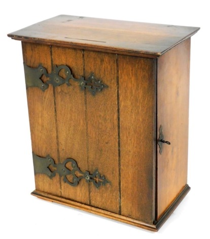 An Edwardian oak cupboard, with elaborate metal hinges and fitted interior, 35cm high, 31cm wide, 18cm deep.