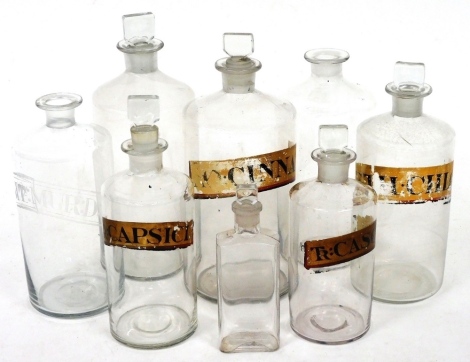 Early 20thC pharmaceutical bottles, some bearing labels, TR: Capsici, etc., 24cm high, and various others mainly with stoppers. (a quantity)