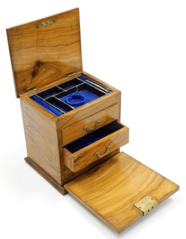 A Victorian olive wood jewellery box, the hinged lid enclosing compartments for a pocket watch, etc., the fall front enclosing three small drawers, 20cm high, 19cm wide, 16cm deep.