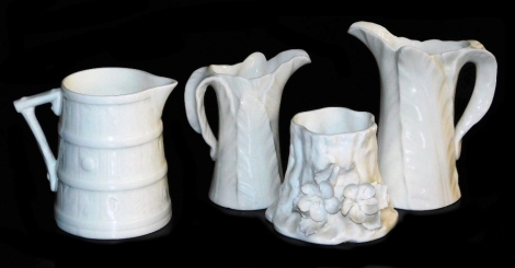 A Royal Worcester white glazed porcelain cream jug, moulded to simulate a barrel, two Worcester cabbage leaf jugs, and a small tree stump vase, encrusted with flowers. (4)