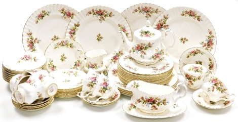 A Royal Albert Moss Rose pattern part tea and dinner service, comprising sauce boat on stand, eight dinner and dessert plates, eight fruit bowls, teapot, cream jug and sugar bowl, bread plate, eight tea cups, saucers and plates.