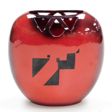 A Peggy Davies ceramics flambe vase, designed by John W Brown, with a pierced top, stencilled in black on a deep red ground, hand written marks, 19cm high.