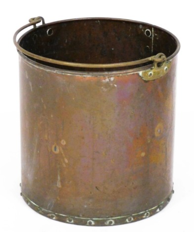 A riveted brass coal bucket with swing handle, 30cm high.