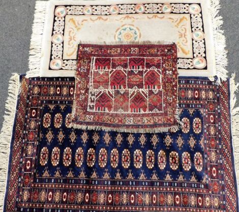 An Afghan type rug, with design of medallions, on a navy ground, Chinese rug and a small Persian mat. (3)