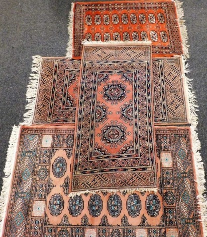 A Pakistan hand knotted rug, in geometric pattern on a peach ground, 83cm wide, various other rugs, hand knotted, etc. (a quantity)