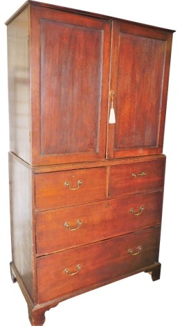 A George III oak linen press, the upper section with fitted drawers raised above two short over two long drawers, on ogee bracket feet, 96cm high, 110cm wide, 58cm deep.