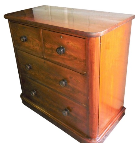 A Victorian figured mahogany chest of drawers, the top with rounded corners above two short over two long drawers, each with turned handles, on a plinth base, 105cm high, 106cm wide, 56cm deep.