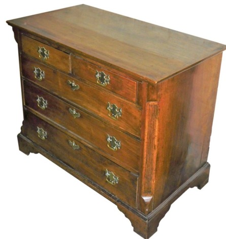 A George III mahogany chest of drawers, the top with a moulded border, above two short over three long drawers, each with brass handles flanking reeded canted sides, on bracket feet, 78cm high, 95cm wide, 53cm deep. (AF)