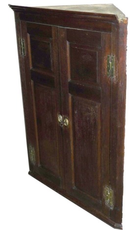 A 19thC oak corner cabinet, with two panelled doors.