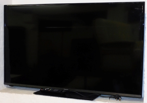 A Panasonic 47" HD colour television, in black trim with remote control and wire.