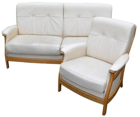 An Ercol cream leather and elm two seater sofa, and a matching armchair.