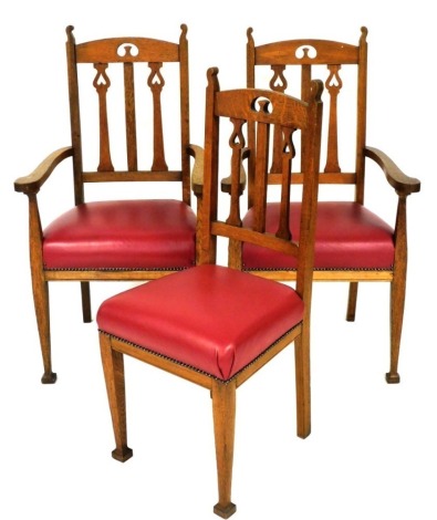 A pair of late Victorian oak Art Nouveau style open armchairs, each with a padded seat, on square tapering legs, and a matching side chair. (3)